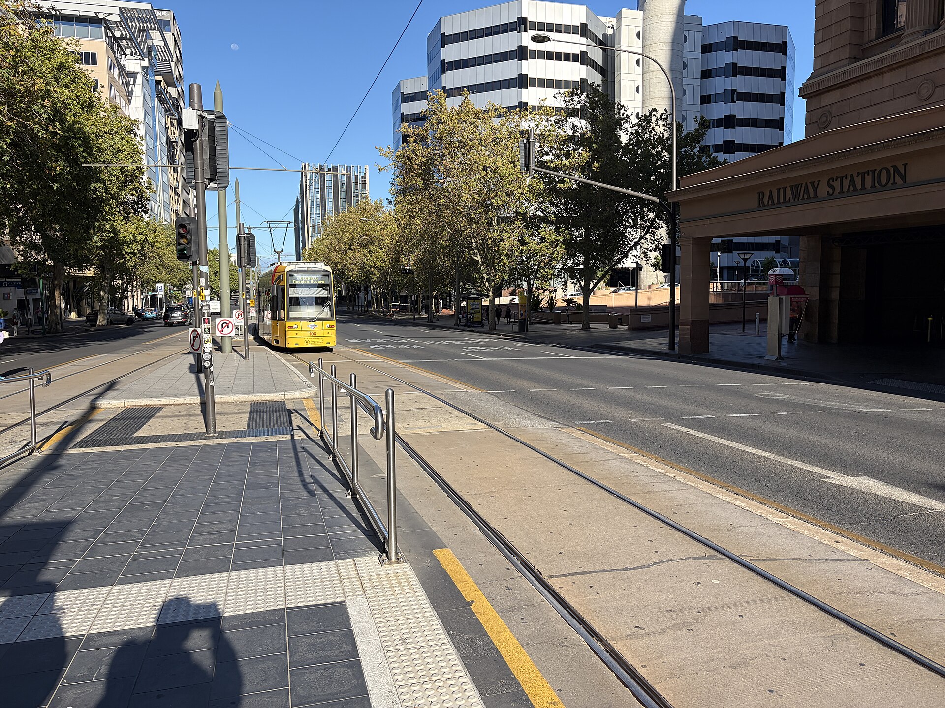 A tram approaching Adelaide Railway Station on North Terrace, March 2026
