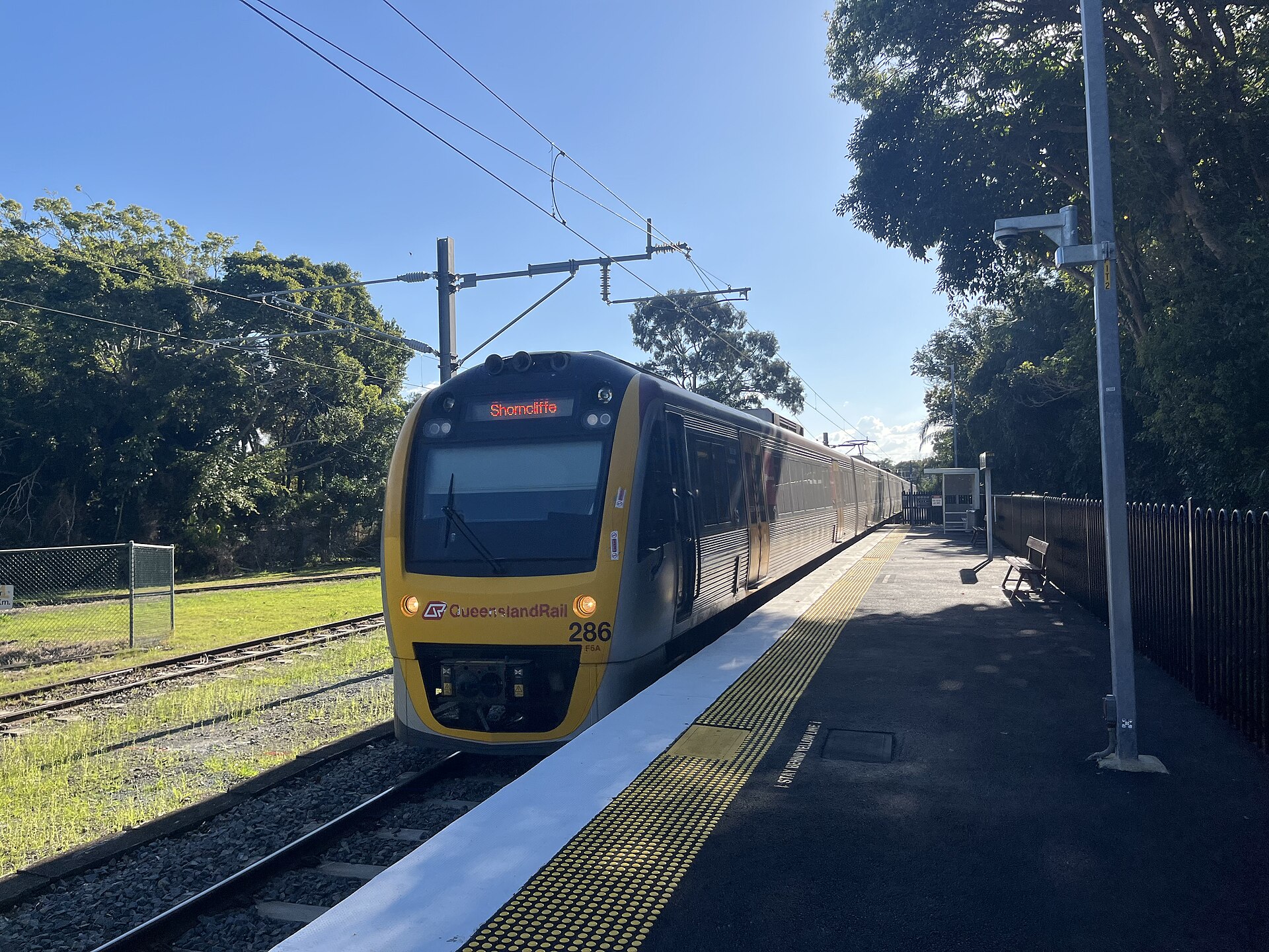 A Queensland Rail train showing Shorncliffe on its destination board, arriving at Shorncliffe station