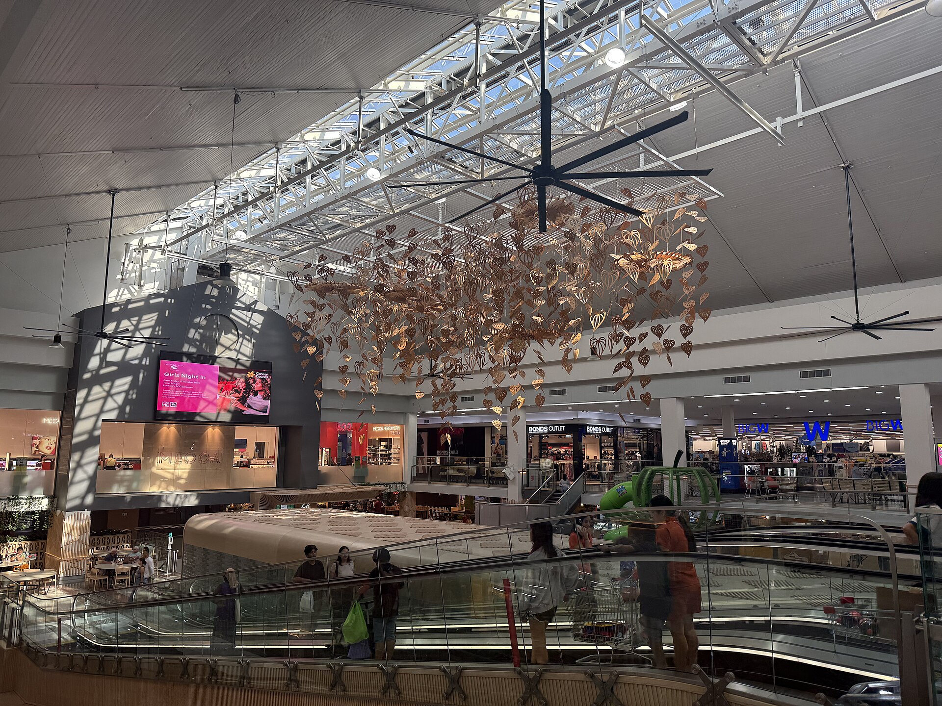 Inside Casuarina Square, Darwin, with a hanging ceiling decoration and shops, photographed in September 2025