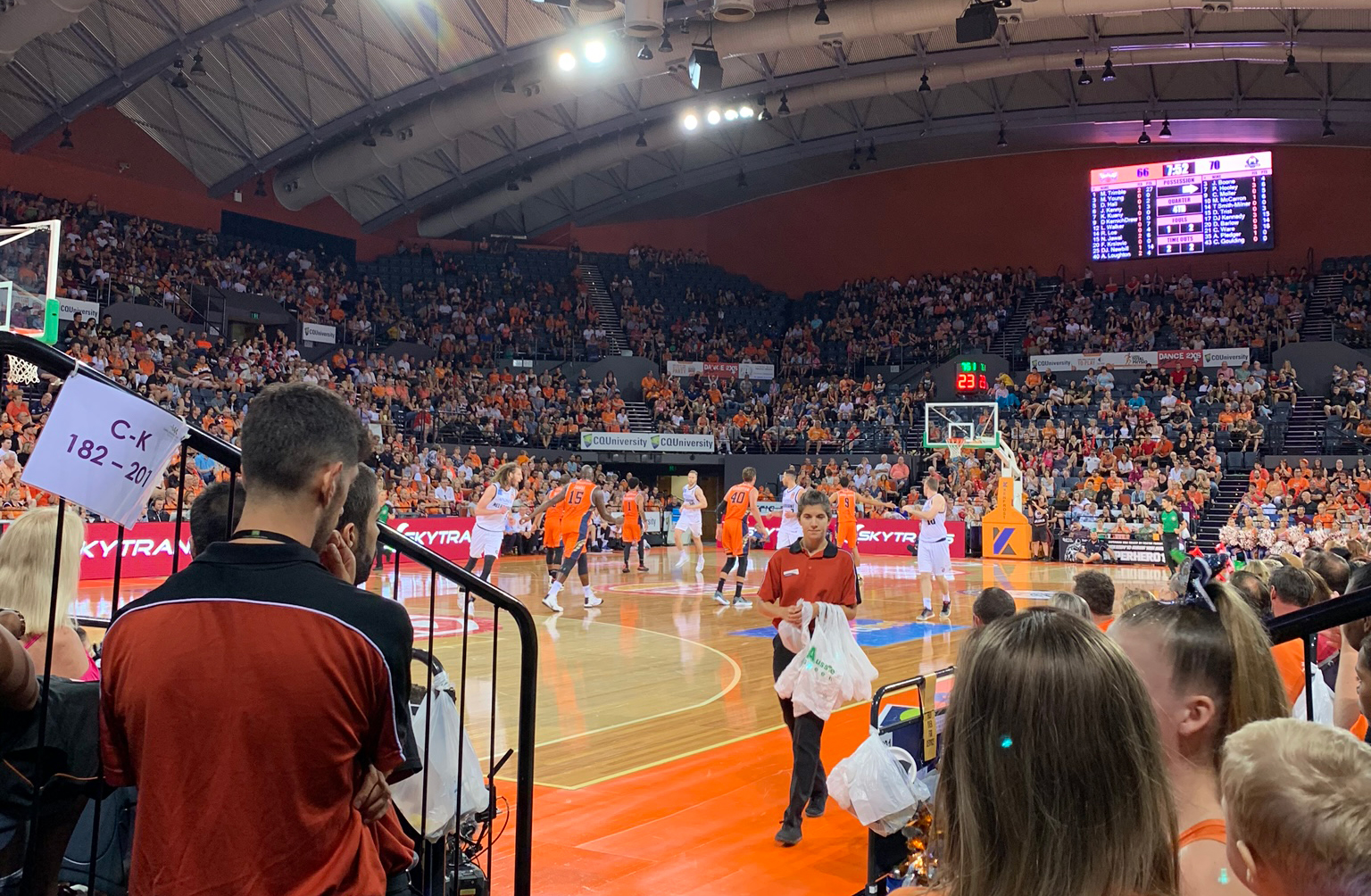 The Cairns Convention Centre arena set up for basketball with a crowd in orange