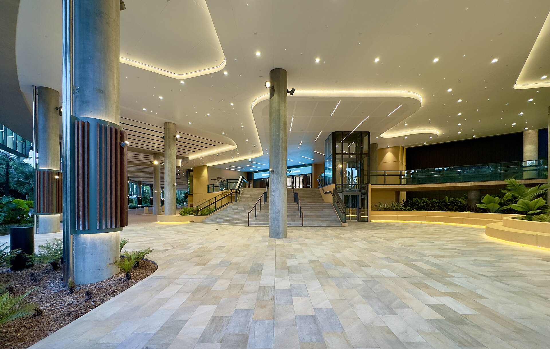 The covered forecourt and entrance stairs of the Cairns Convention Centre in the evening
