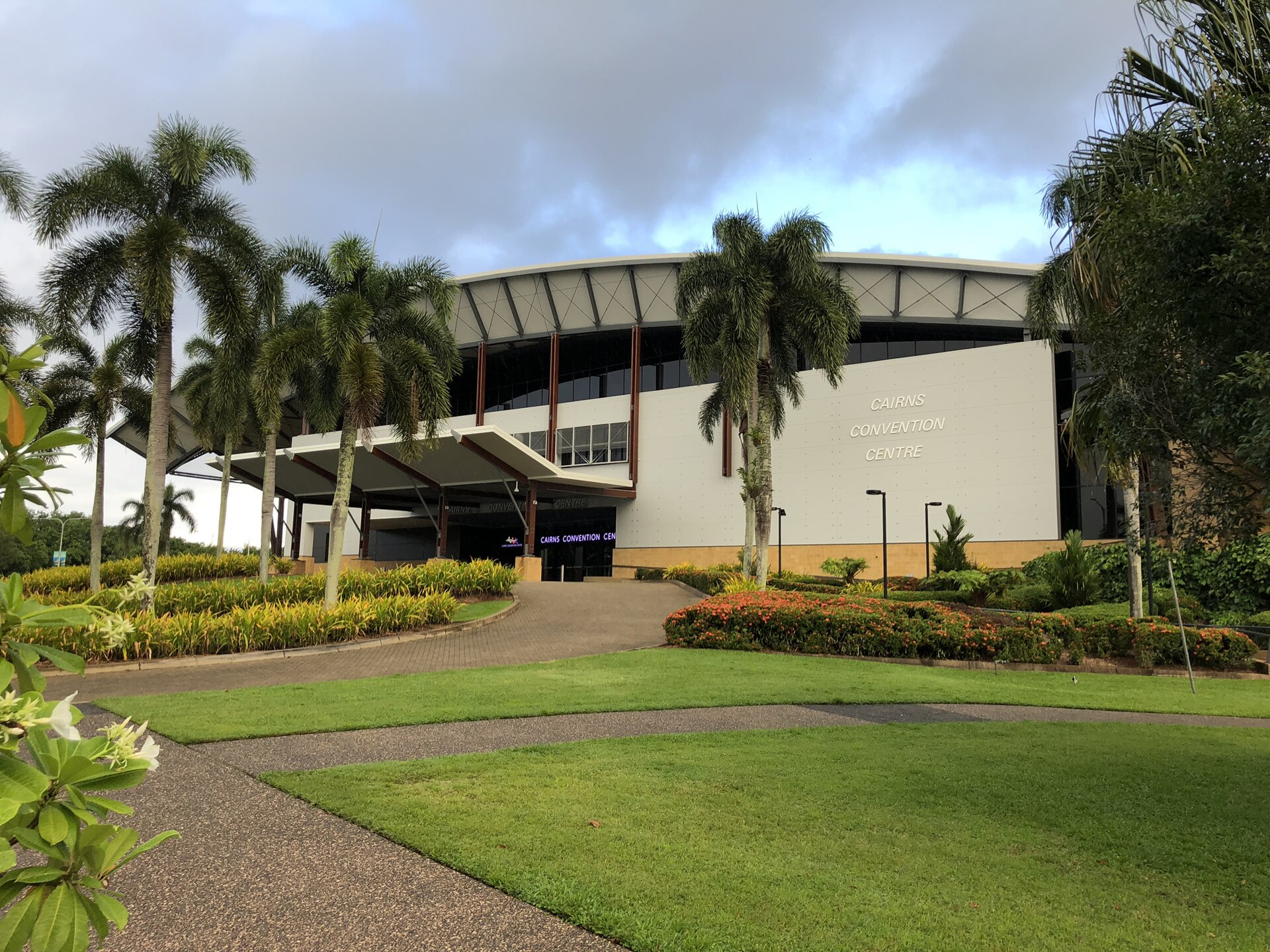 The Cairns Convention Centre seen from the Wharf Street side, with palm trees in the foreground