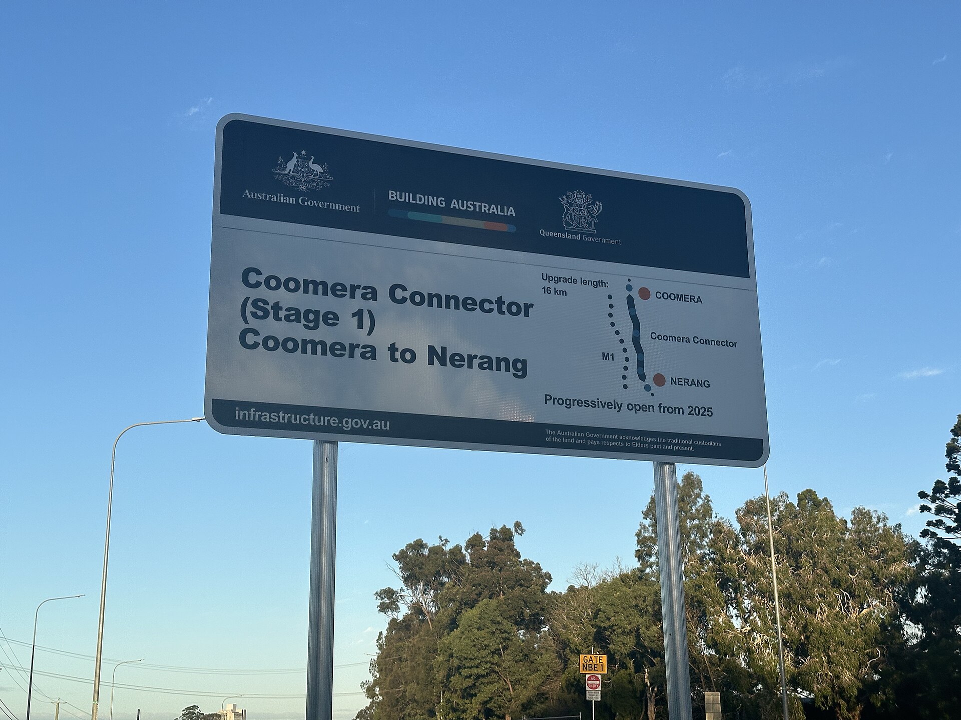 A second view of the Coomera Connector Stage 1 sign on Nerang-Broadbeach Road, June 2026