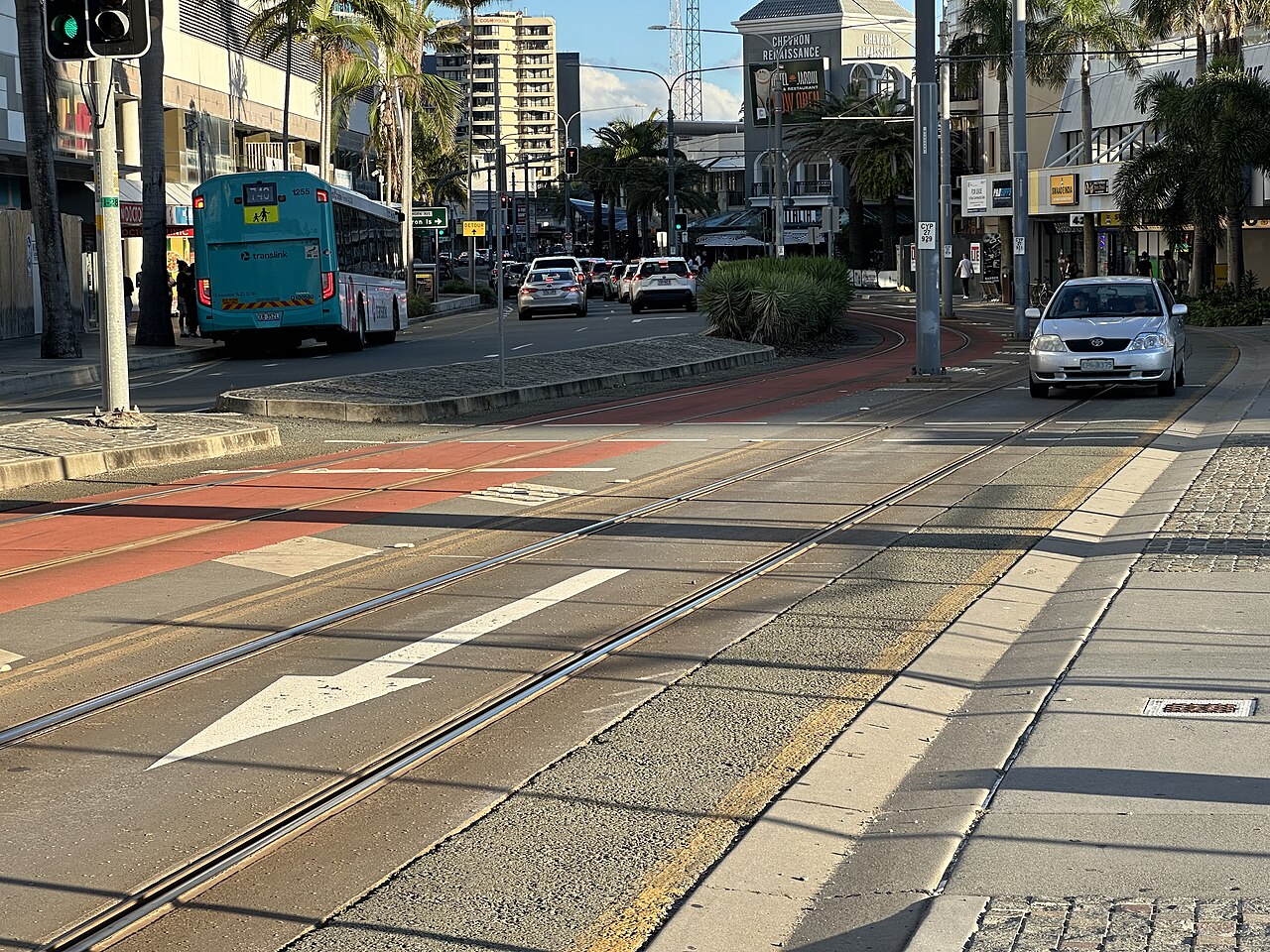 Surfers Paradise Boulevard near Cypress Avenue light rail station with a Translink bus and cars