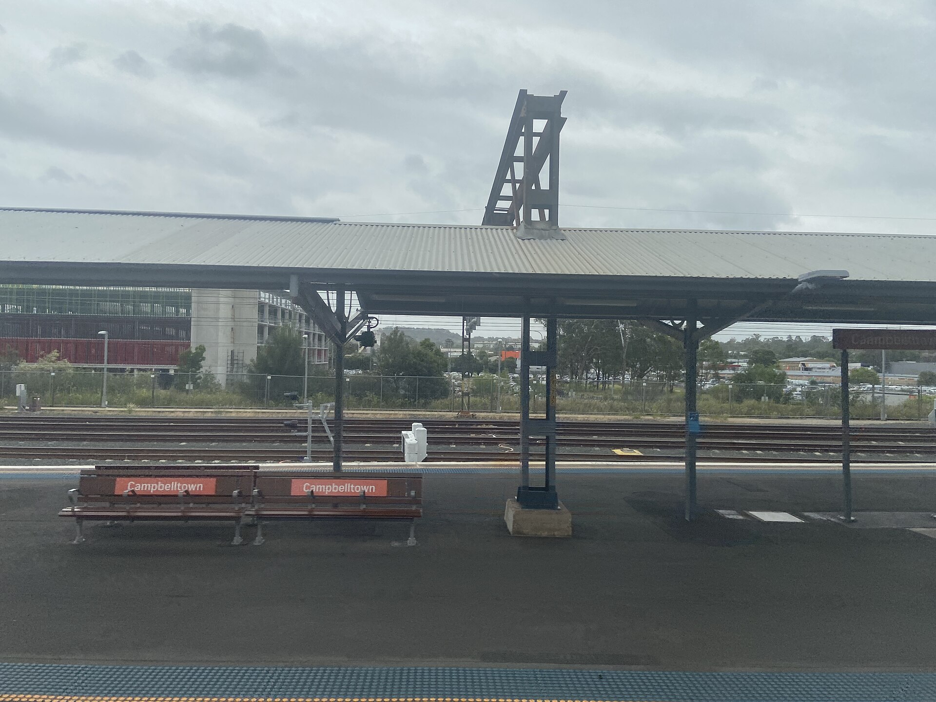Platform seating with Campbelltown signs at Campbelltown station, January 2025