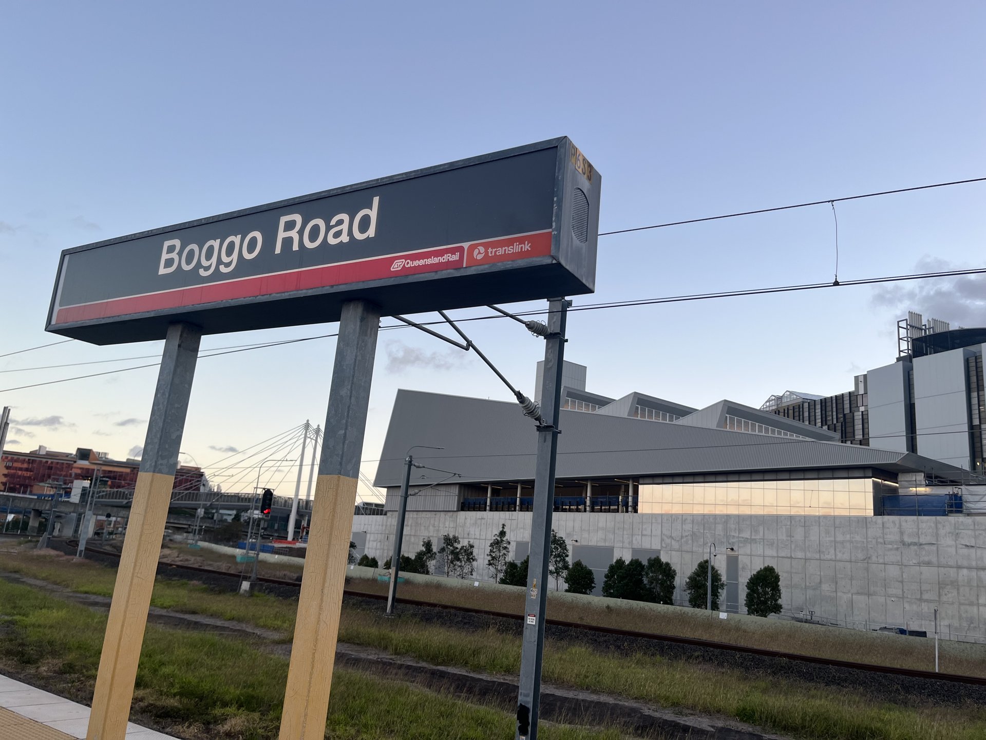 Boggo Road station sign beside the Cross River Rail station building in Brisbane