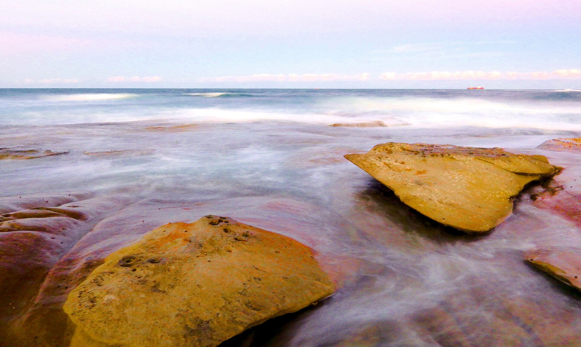 Waves washing over rocks at Moffat Beach, Caloundra, Queensland