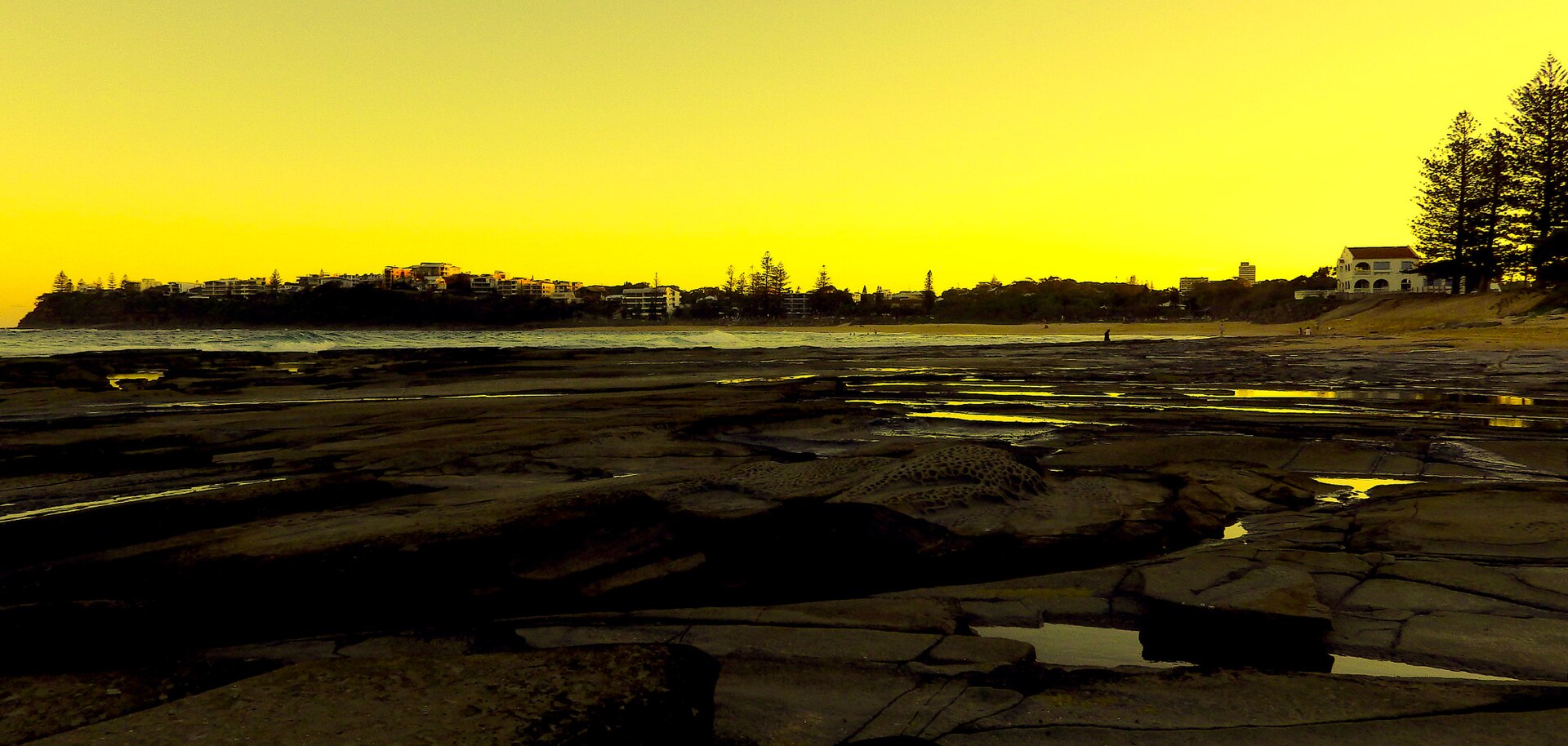 Moffat Beach, Caloundra, Queensland, with the headland in the distance; the photographer's colours are heavily edited
