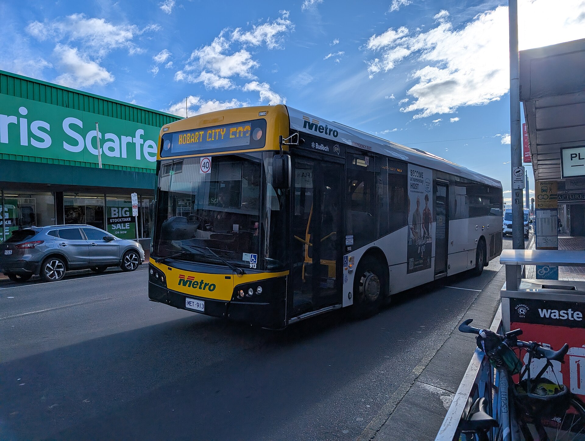 A Metro bus on route 503 to Hobart City at a Main Road stop in Moonah