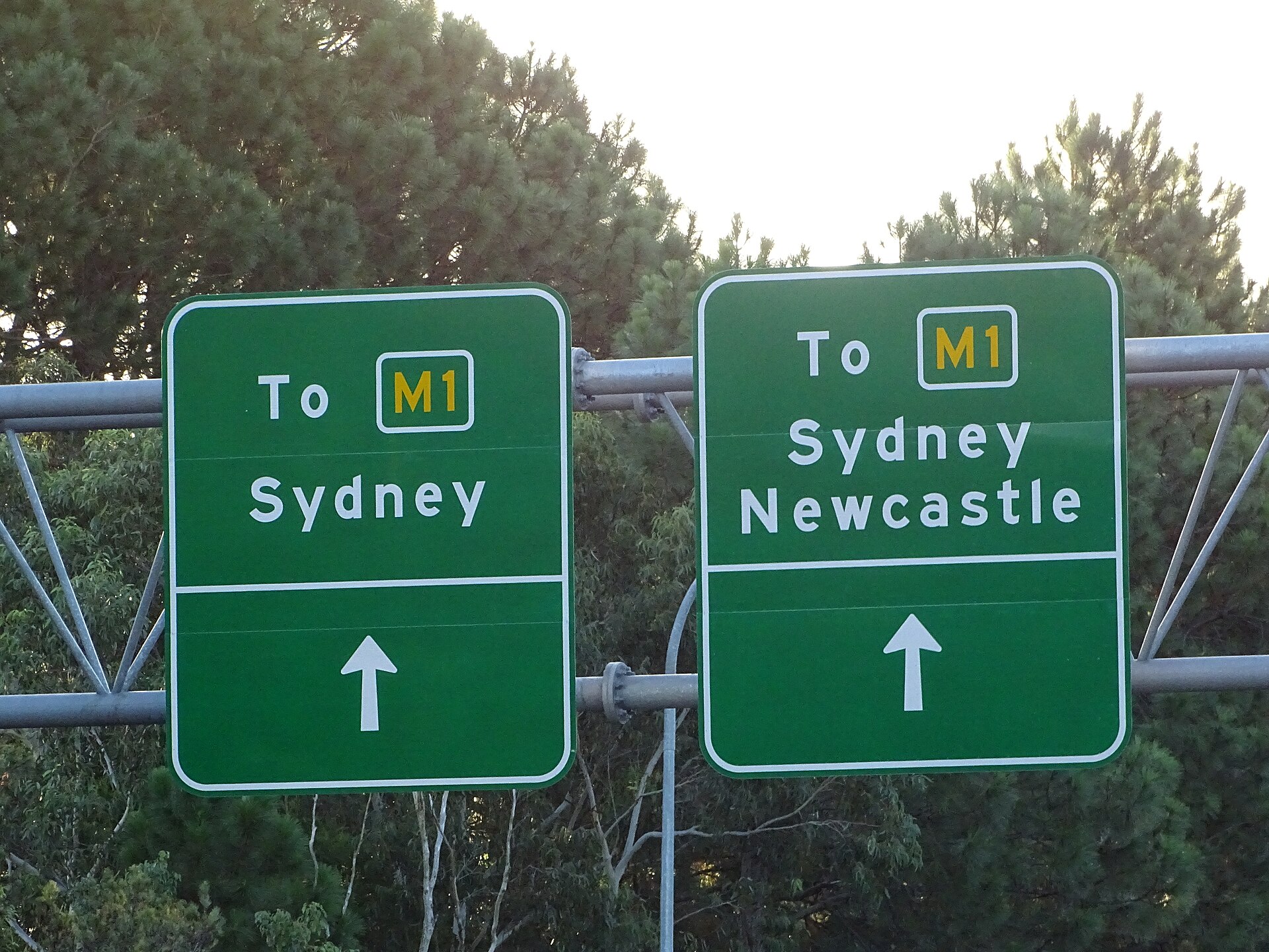 Green M1 signs on the Central Coast Highway at Kariong pointing to Sydney and to Sydney and Newcastle