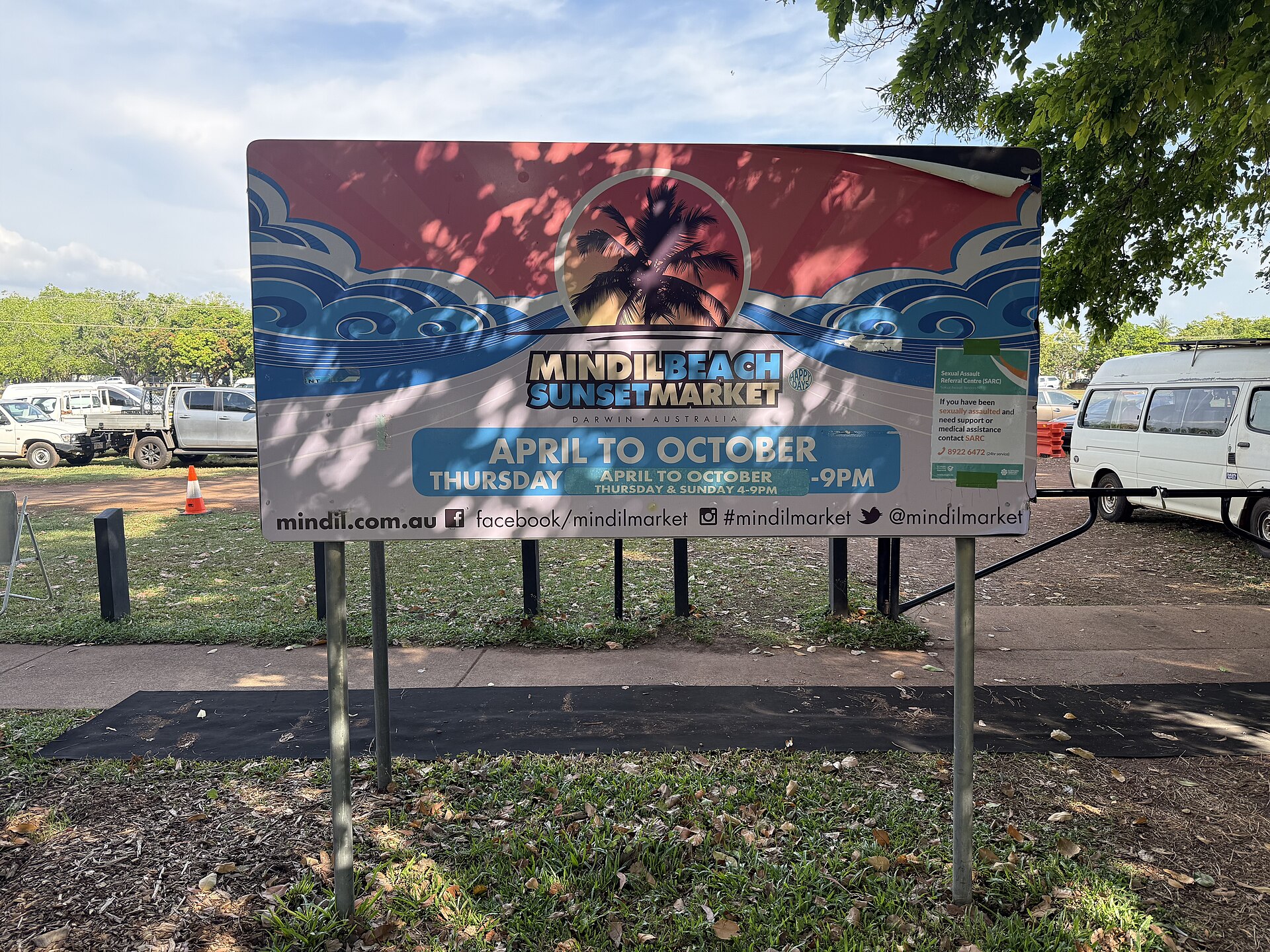 Mindil Beach Sunset Market sign showing April to October, Thursday and Sunday, photographed in October 2025
