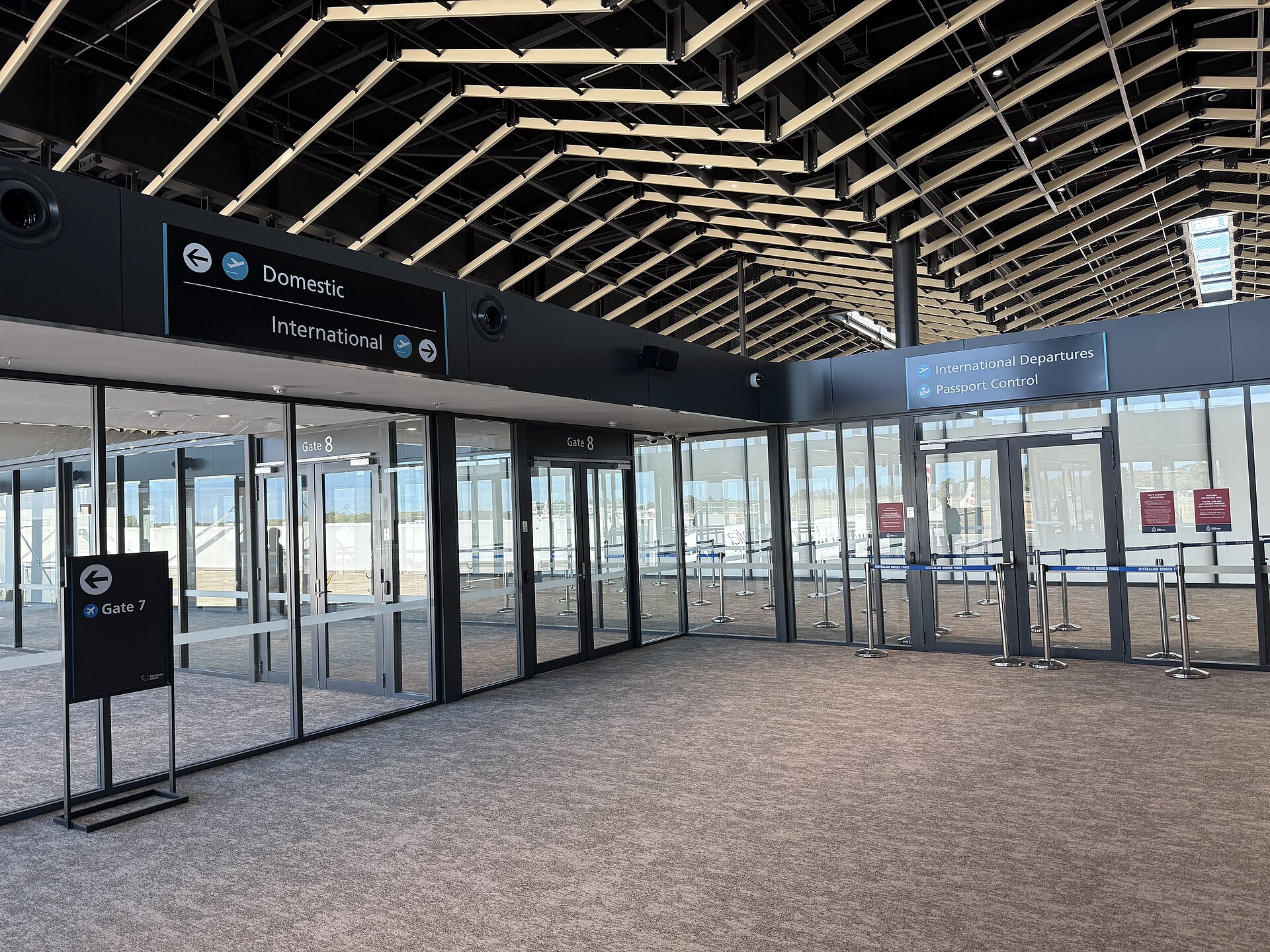 Domestic and international departures signs inside Newcastle Airport, December 2025