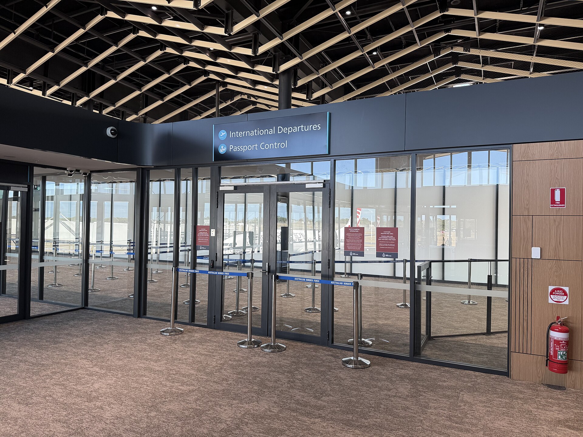 International departures and passport control signs inside Newcastle Airport, December 2025