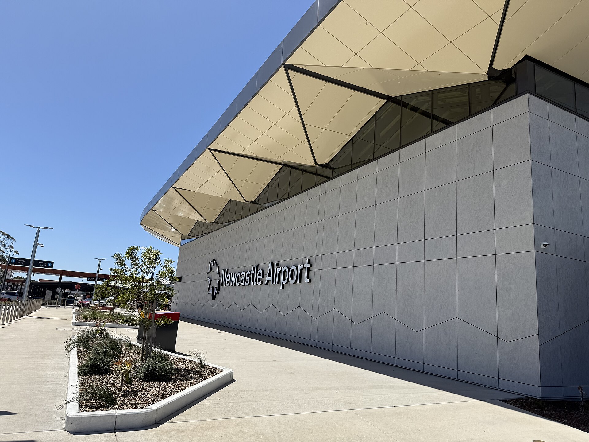 The Newcastle Airport sign on the terminal building at Williamtown, December 2025