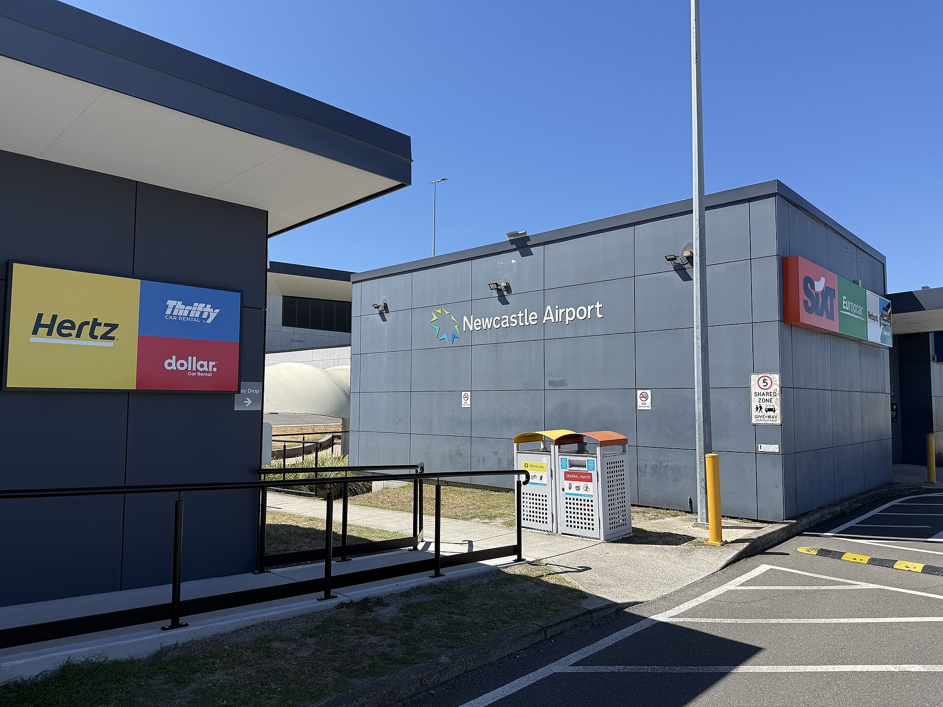 Newcastle Airport car rental buildings near the terminal, photographed in December 2025