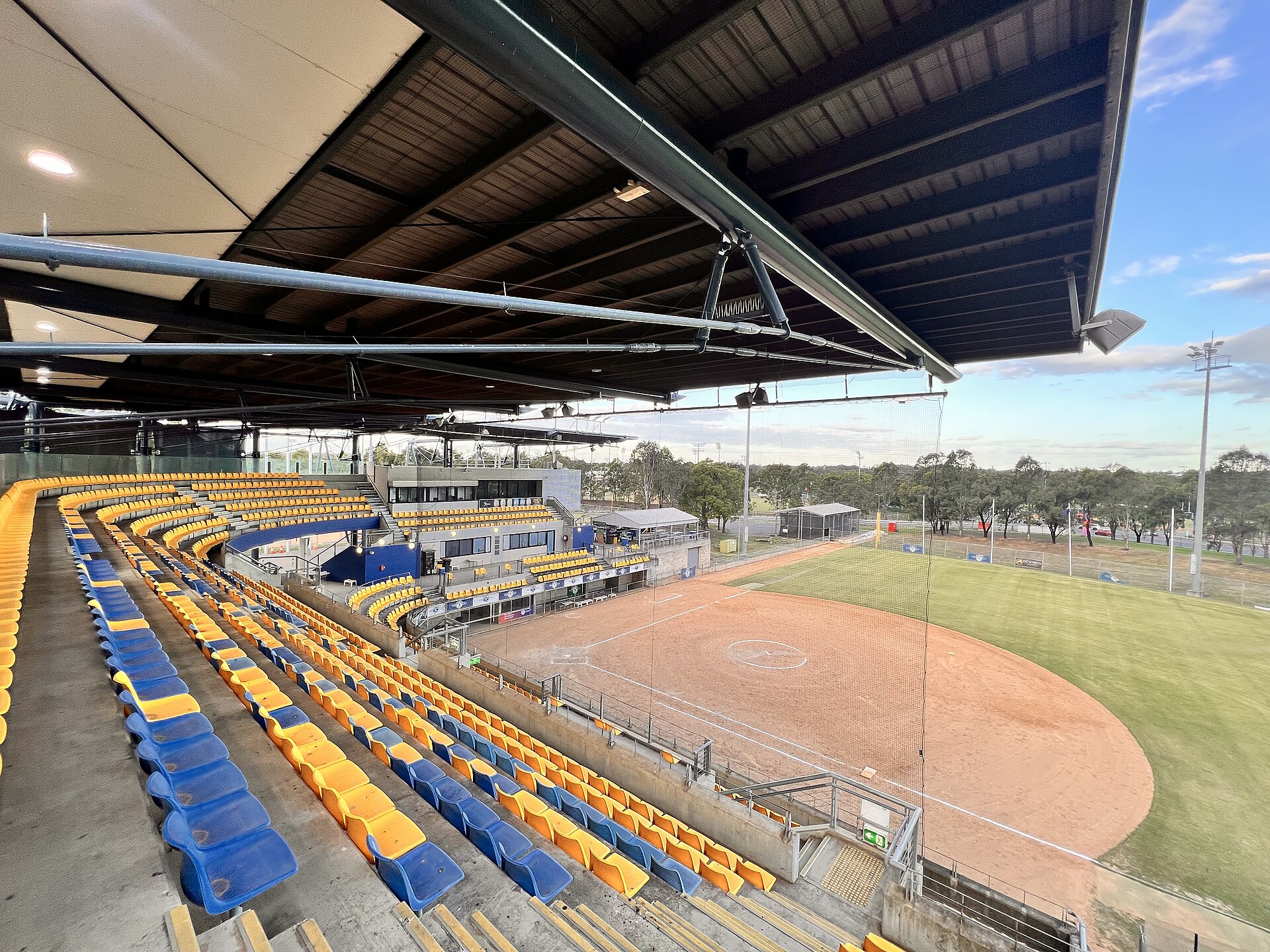 Empty grandstand seating and a field at the Blacktown Softball Stadium inside Blacktown International Sports Park, Rooty Hill