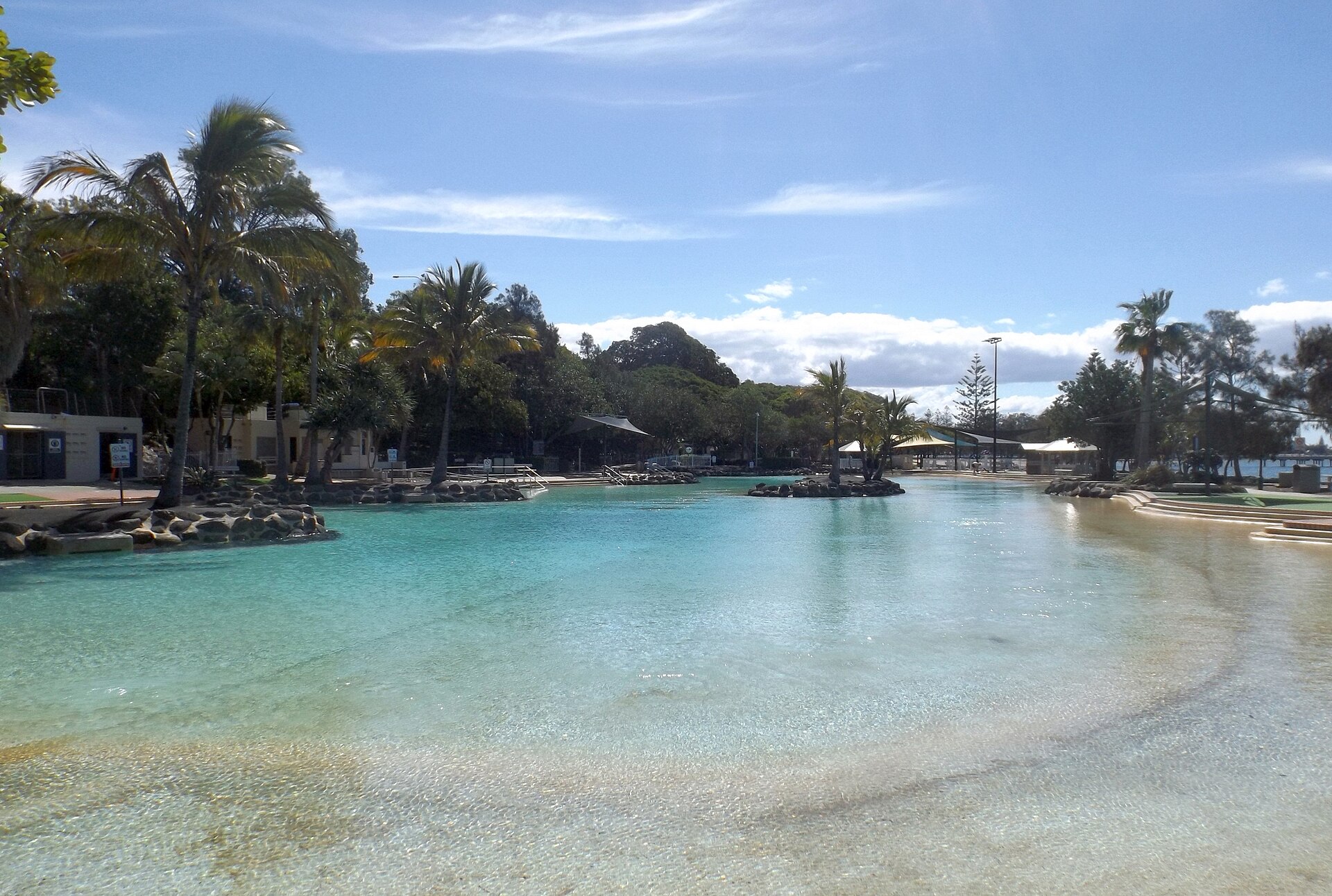 The Redcliffe lagoon with palm trees and a jetty in the distance