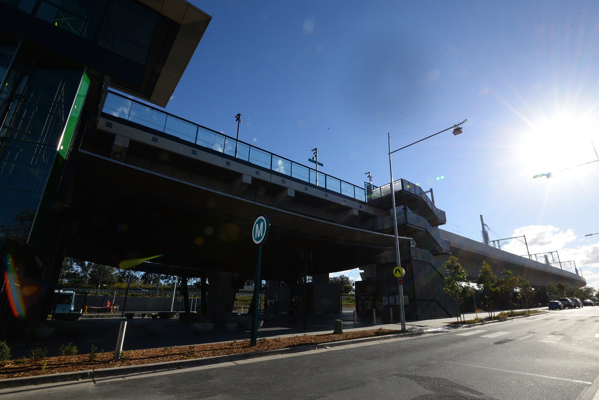 Rouse Hill Metro Station seen from the street, with the Metro M sign and an elevated platform