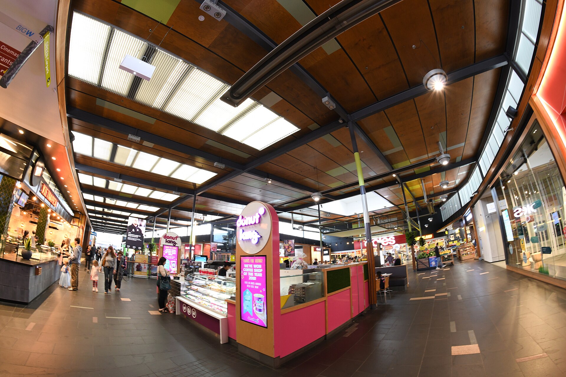 A food and shopping area inside Rouse Hill Town Centre with a Big W sign and a donut kiosk