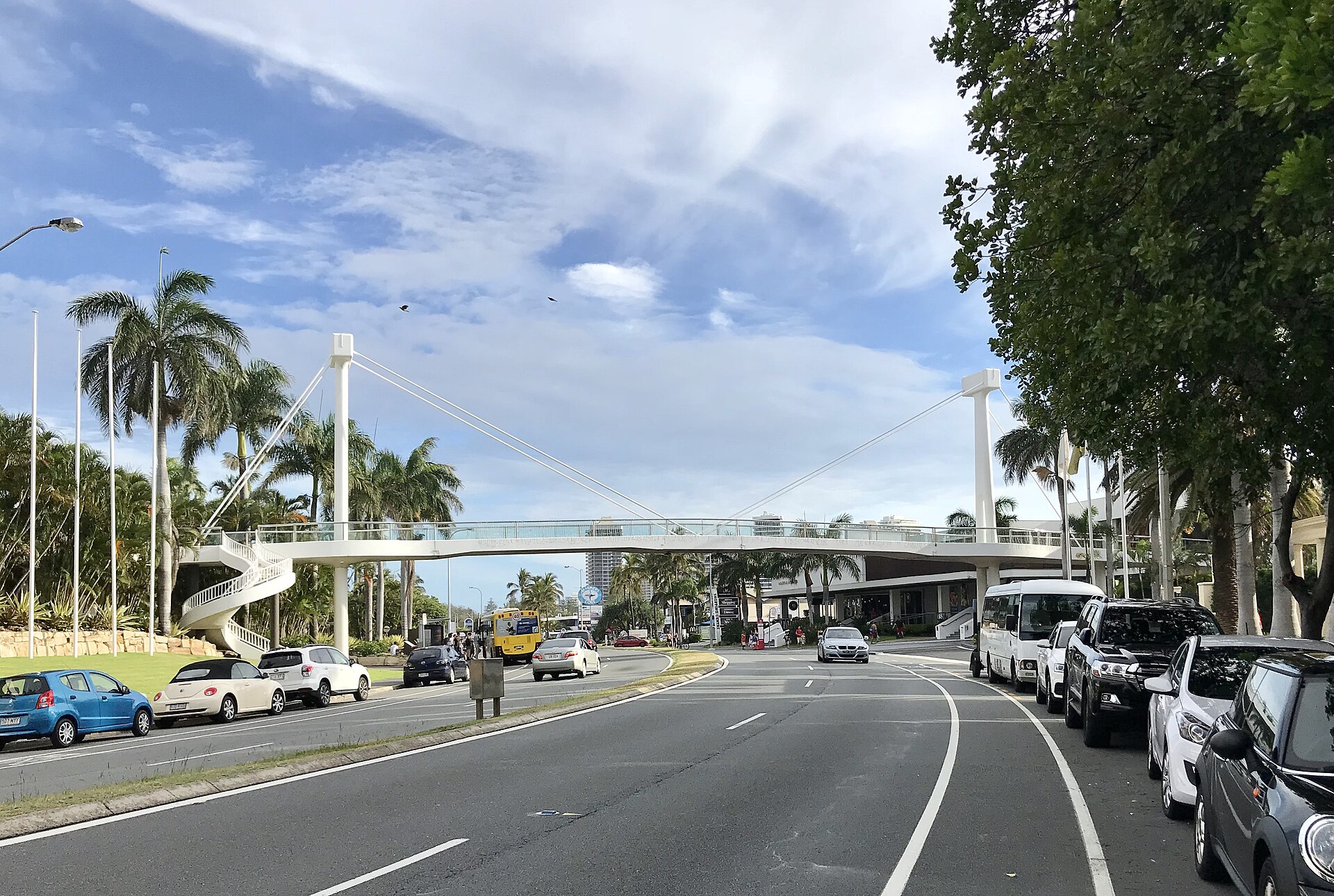 The pedestrian bridge over Seaworld Drive at Main Beach, with a bus stopped beyond it (photo taken in 2017)
