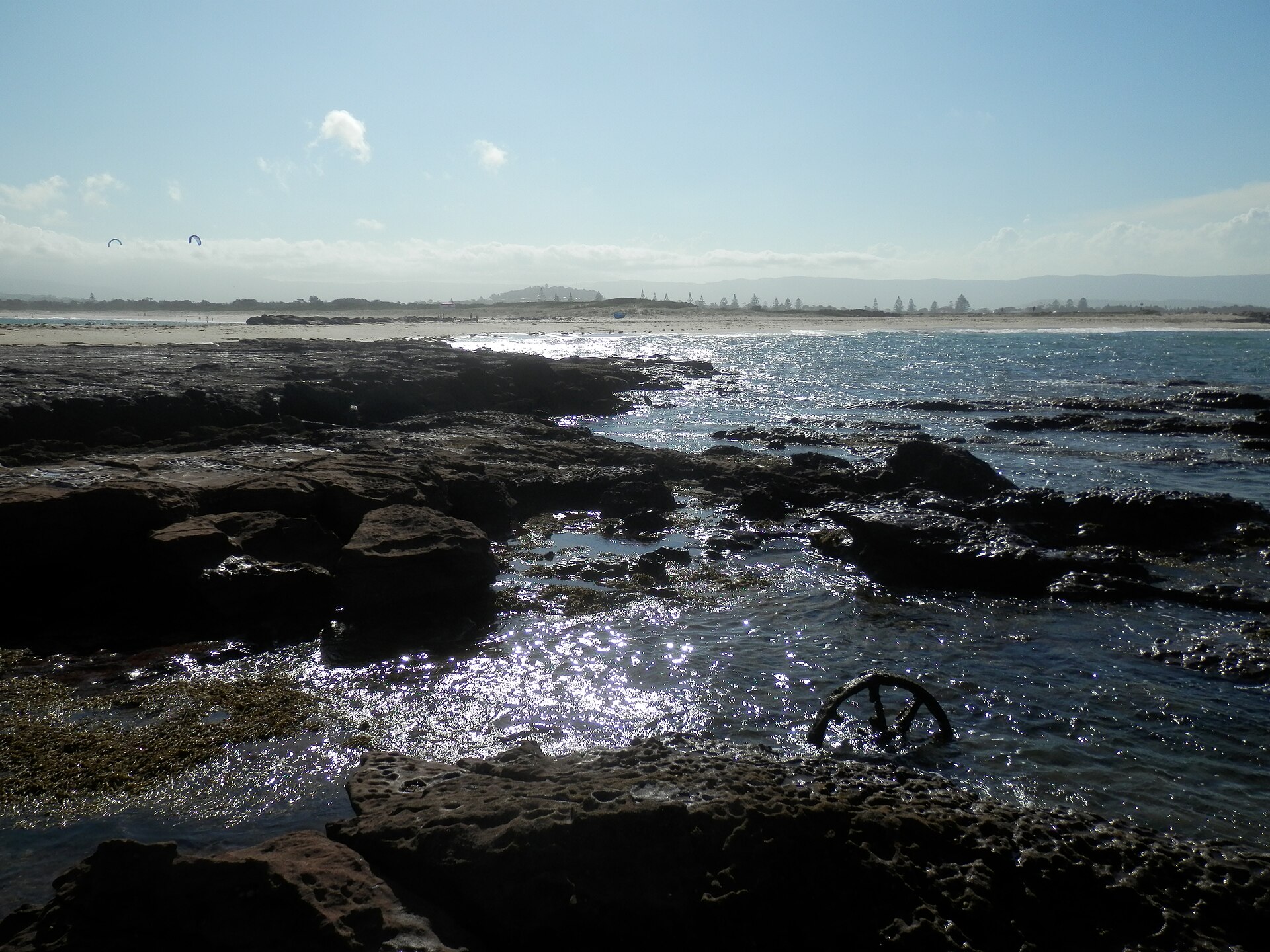 Rock platform on Windang Island with the Warilla shoreline in the distance, NSW