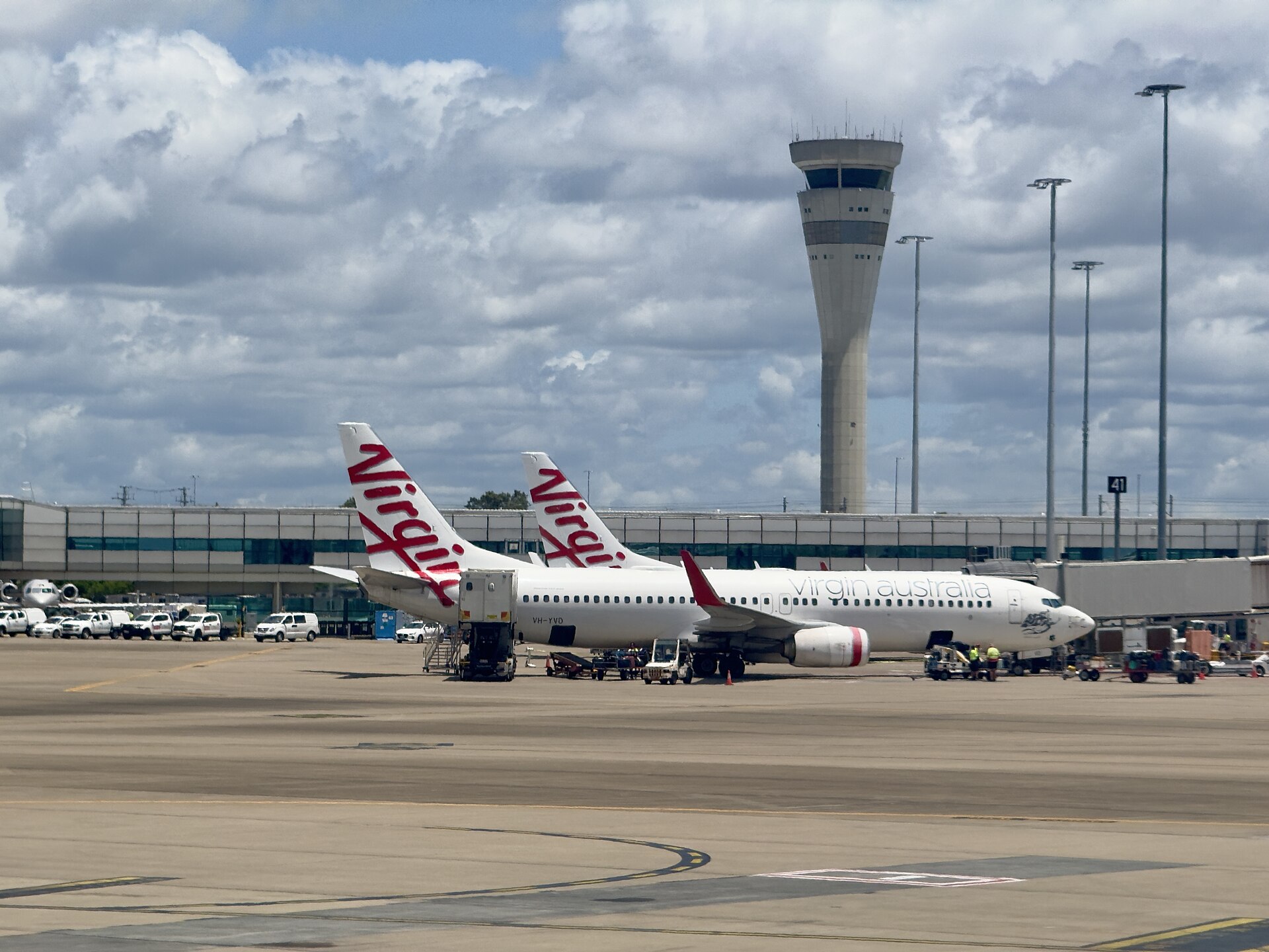 Virgin Australia aircraft and the control tower at Brisbane Airport (photographed in 2025)