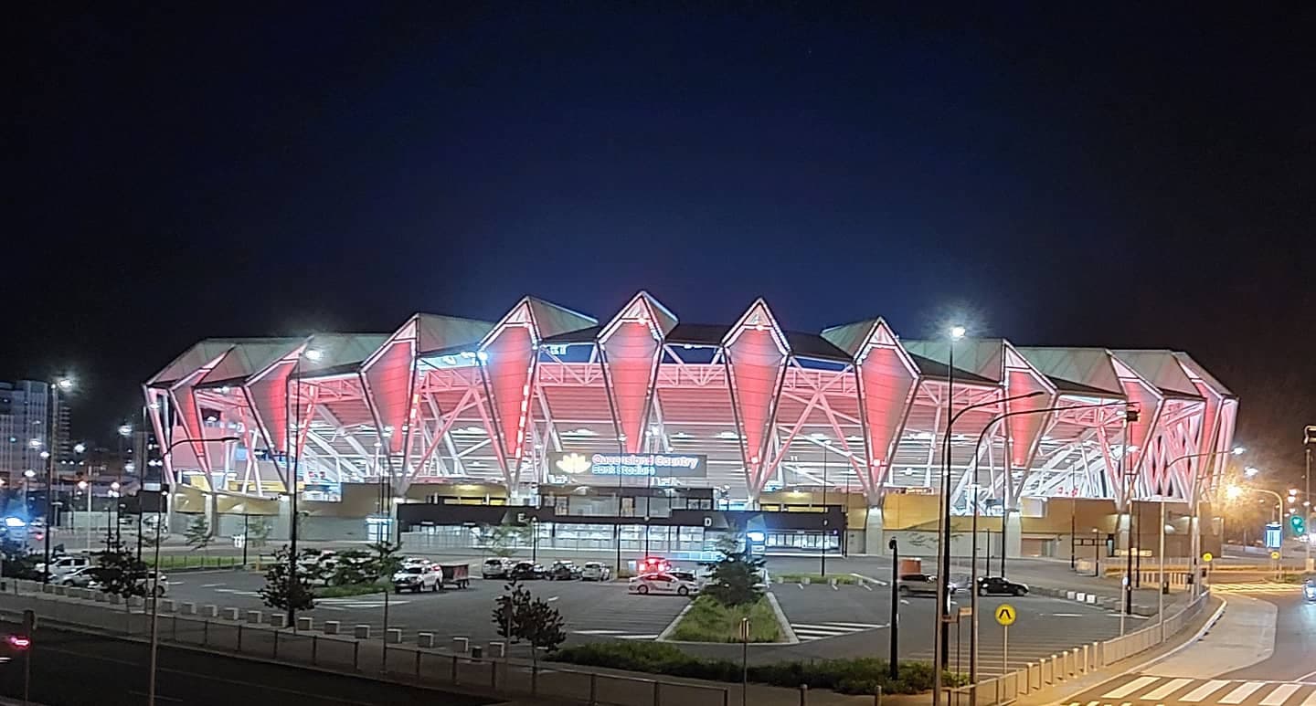 Queensland Country Bank Stadium at night, seen from the nearby pedestrian bridge