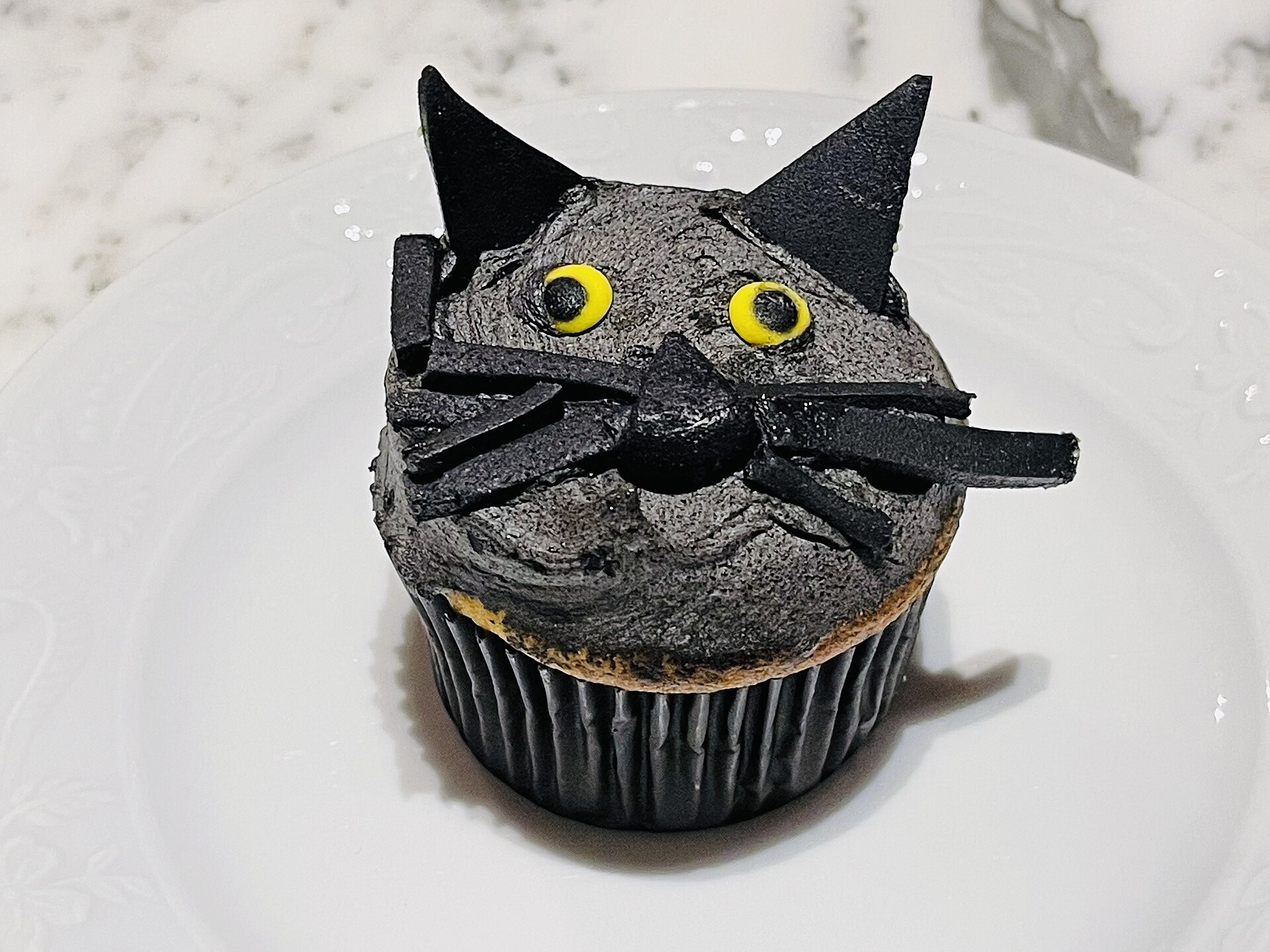 A black cat cupcake made for Halloween in Australia, 2021