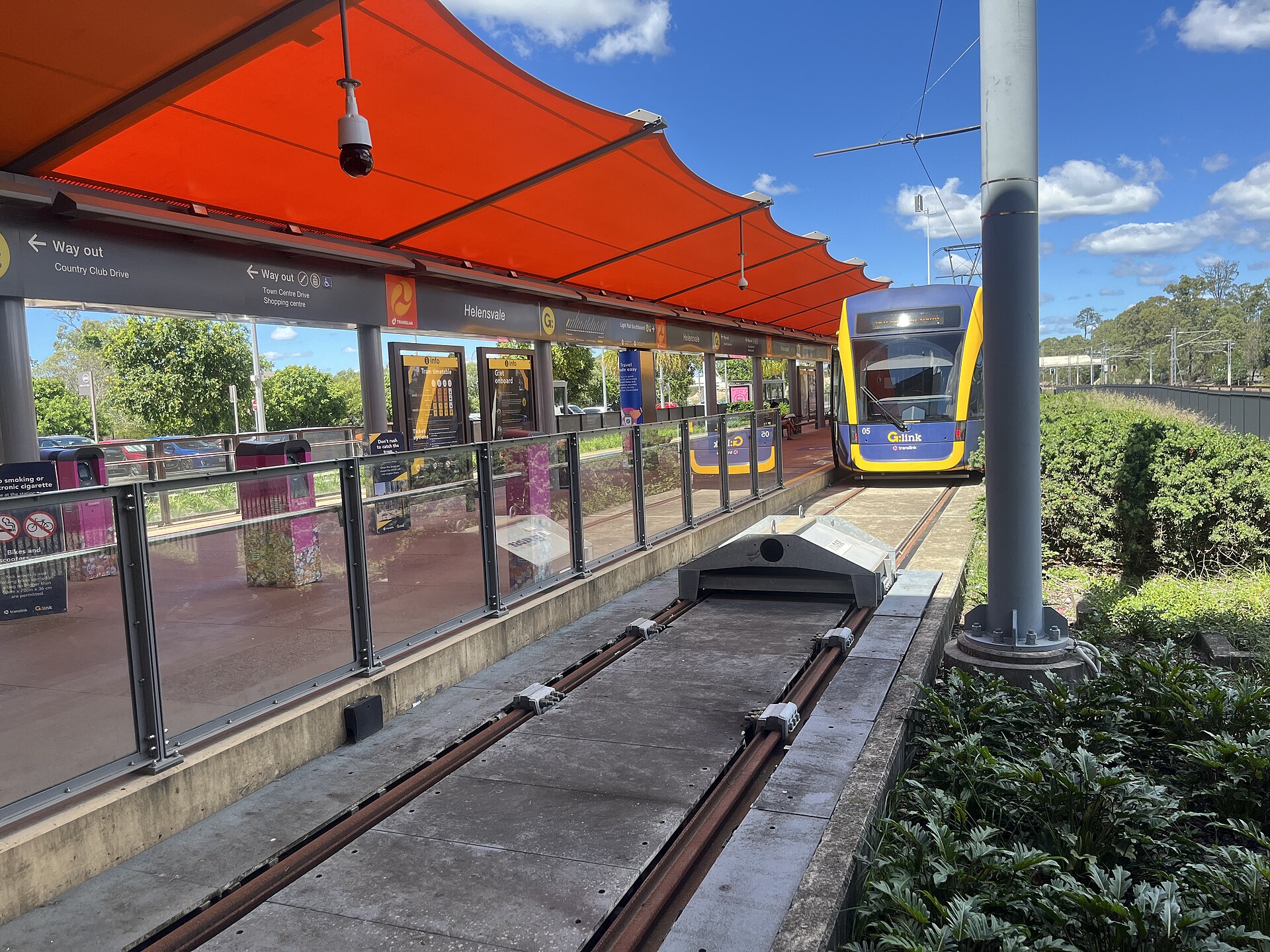 Helensvale light rail station, platform 4, with a tram arriving
